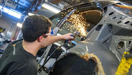 Autobody repair student working on vehicle